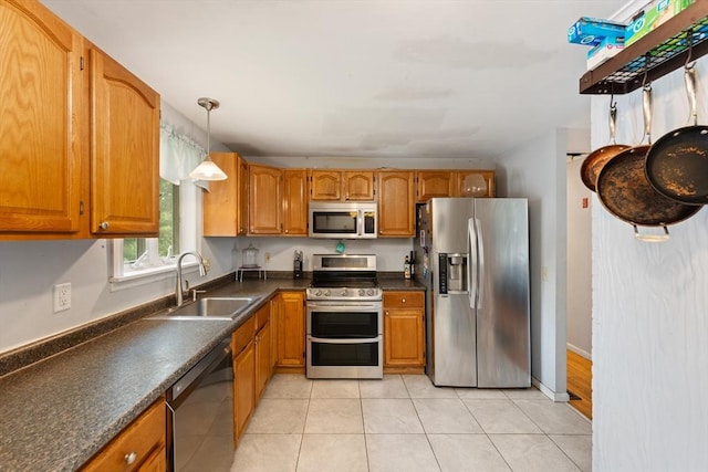 140 W Mountain St, Worcester, MA 01606 - kitchen featuring stainless steel appliances, a sink, dark countertops, and brown cabinetry