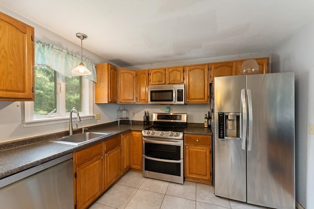 140 W Mountain St, Worcester, MA 01606 - kitchen featuring appliances with stainless steel finishes, a sink, brown cabinetry, and dark countertops