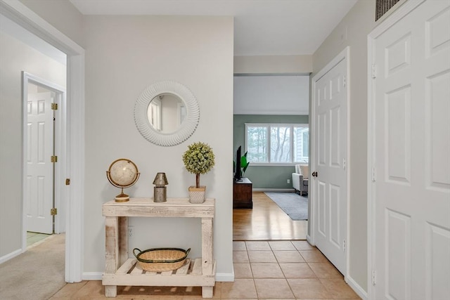 hall with light tile patterned floors