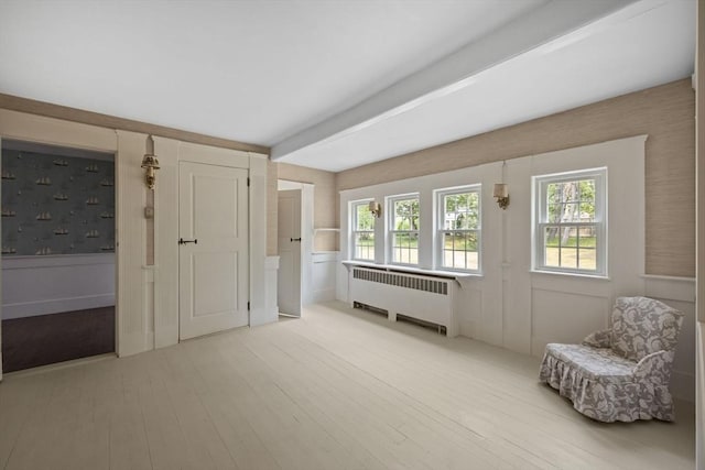 36 Uncle Barneys Rd, Dennis, MA 02670 - sitting room with radiator, light wood finished floors, and healthy amount of natural light