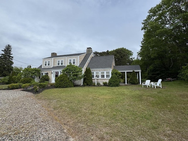 36 Uncle Barneys Rd, Dennis, MA 02670 - back of house featuring a lawn and a chimney