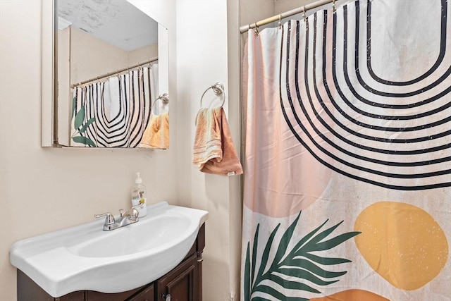 bathroom featuring curtained shower and vanity