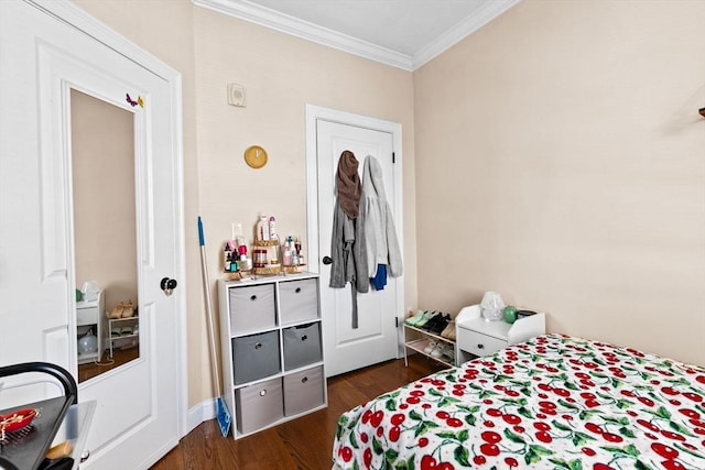 bedroom with ornamental molding and dark wood-style floors