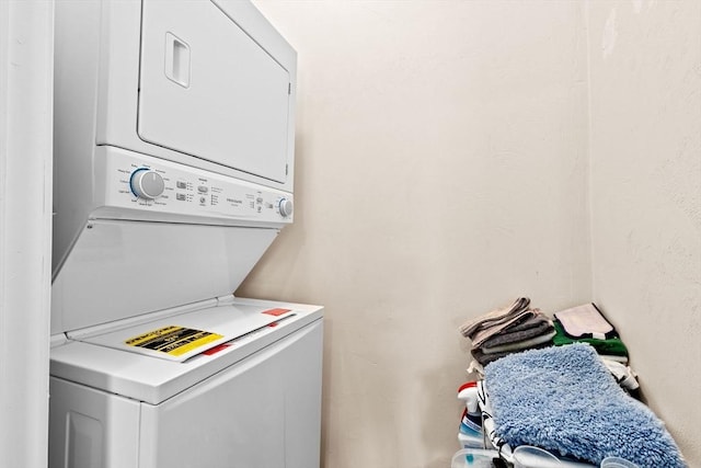 laundry area with stacked washing maching and dryer and laundry area