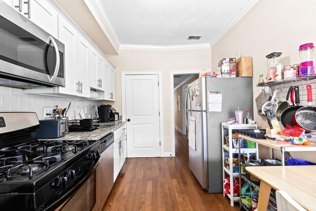 kitchen with white cabinetry, ornamental molding, visible vents, and stainless steel appliances