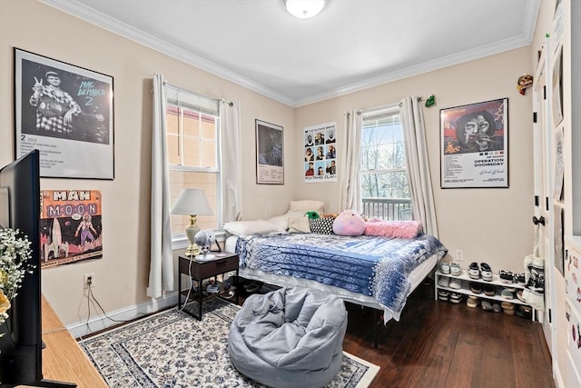 bedroom with ornamental molding, baseboards, and wood finished floors