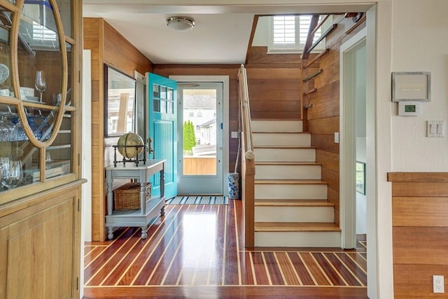 13 Selman St, Marblehead, MA 01945 - entrance foyer with plenty of natural light, stairway, wood finished floors, and wooden walls