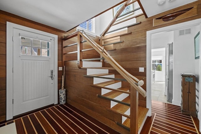 13 Selman St, Marblehead, MA 01945 - entryway featuring wooden walls, healthy amount of natural light, and stairs