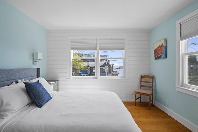 13 Selman St, Marblehead, MA 01945 - bedroom featuring wood finished floors, wood walls, and baseboards