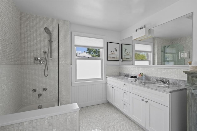 13 Selman St, Marblehead, MA 01945 - bathroom featuring double vanity, healthy amount of natural light, tile patterned flooring, and wainscoting
