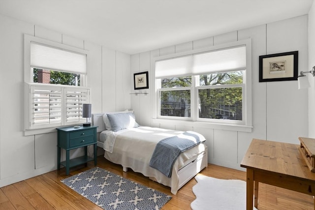 13 Selman St, Marblehead, MA 01945 - bedroom featuring multiple windows, light wood-style floors, and a decorative wall