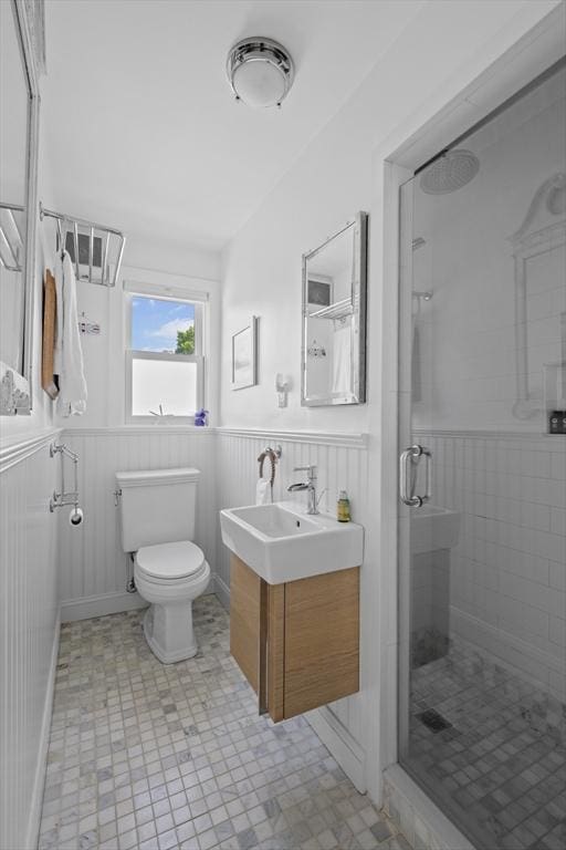 13 Selman St, Marblehead, MA 01945 - bathroom featuring a wainscoted wall, a shower stall, toilet, and vanity