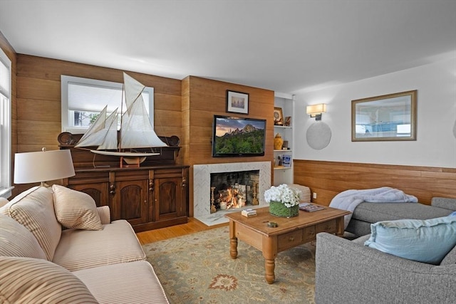 13 Selman St, Marblehead, MA 01945 - living area featuring light wood-type flooring, wooden walls, and a high end fireplace