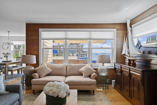13 Selman St, Marblehead, MA 01945 - living area featuring a chandelier, light wood-style floors, and wood walls