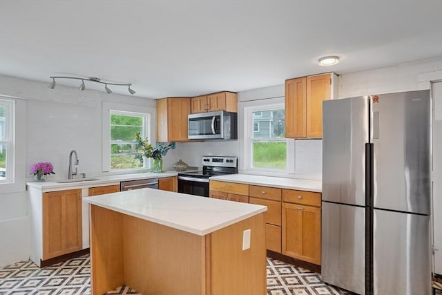 12 Temple Ave, Hudson, MA 01749 - kitchen with stainless steel appliances, a sink, light floors, and a kitchen island