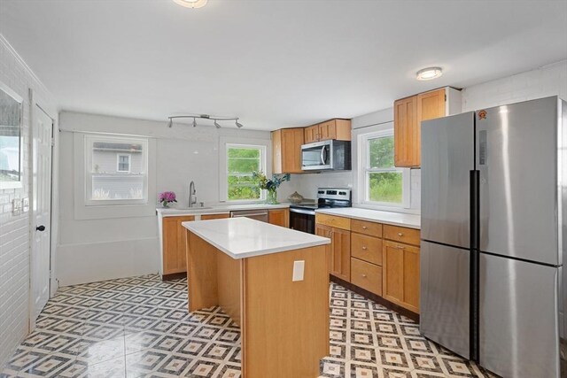 12 Temple Ave, Hudson, MA 01749 - kitchen with stainless steel appliances, light countertops, light flooring, a center island, and a sink