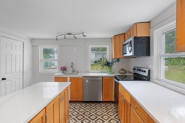12 Temple Ave, Hudson, MA 01749 - kitchen featuring stainless steel appliances, a sink, light stone countertops, and decorative backsplash