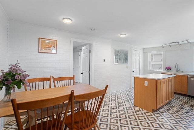 12 Temple Ave, Hudson, MA 01749 - dining room featuring brick wall, light floors, and ornamental molding