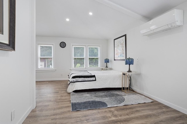 12 Temple Ave, Hudson, MA 01749 - bedroom featuring an AC wall unit, wood finished floors, recessed lighting, and baseboards