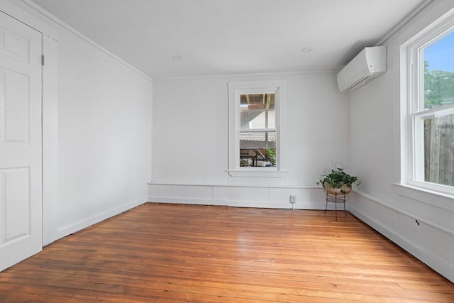 12 Temple Ave, Hudson, MA 01749 - unfurnished room featuring a wall unit AC, light wood-style flooring, crown molding, and baseboards