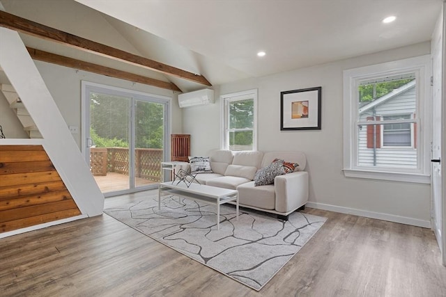 12 Temple Ave, Hudson, MA 01749 - living room with a wall mounted AC, healthy amount of natural light, stairs, wood finished floors, and lofted ceiling