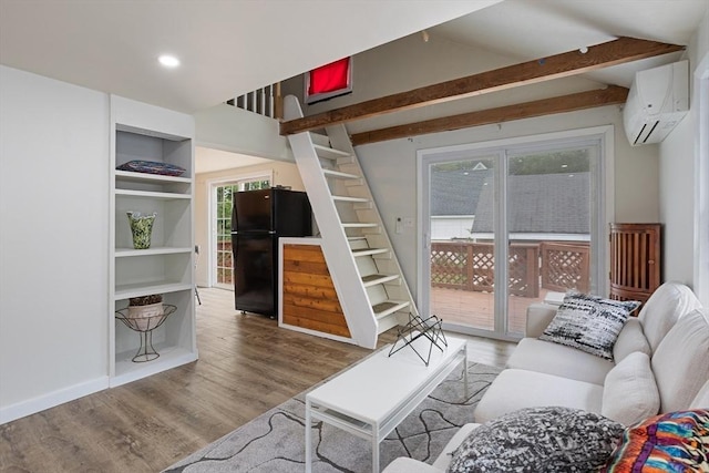 12 Temple Ave, Hudson, MA 01749 - living area with a wall mounted AC, wood finished floors, lofted ceiling, and recessed lighting