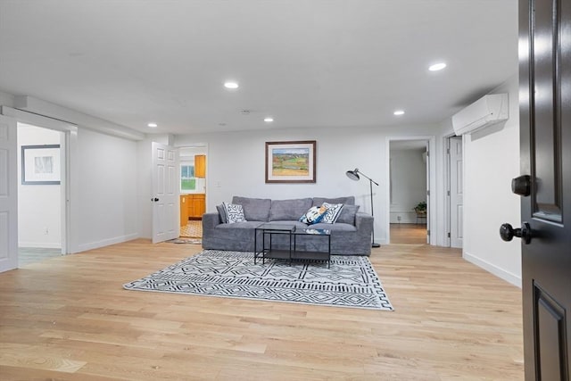 12 Temple Ave, Hudson, MA 01749 - living room with a wall unit AC, light wood-style flooring, baseboards, and recessed lighting