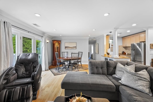 21 Starr Dr Unit 207, Narragansett, RI 02882 - living room featuring decorative columns, recessed lighting, light wood-type flooring, and crown molding