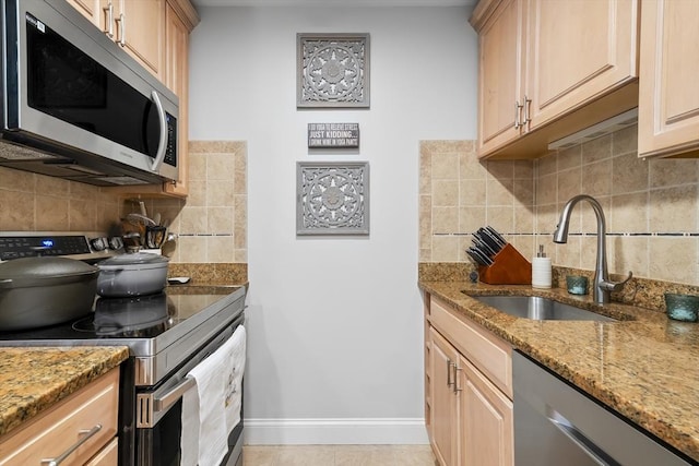 21 Starr Dr Unit 207, Narragansett, RI 02882 - kitchen with stainless steel appliances, decorative backsplash, and light stone counters