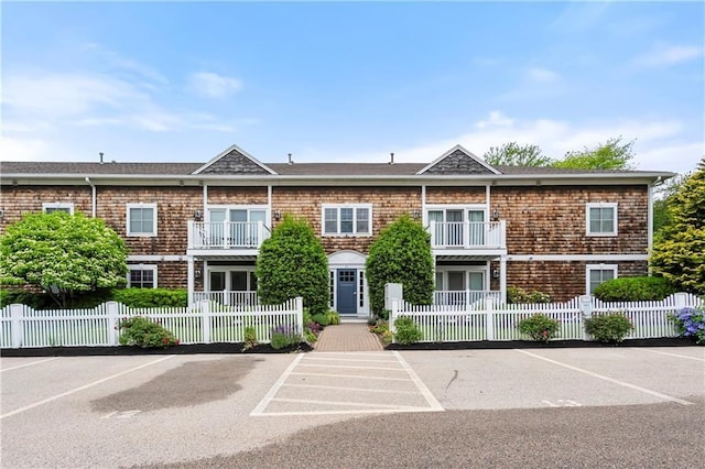 21 Starr Dr Unit 207, Narragansett, RI 02882 - view of building exterior with uncovered parking and a fenced front yard