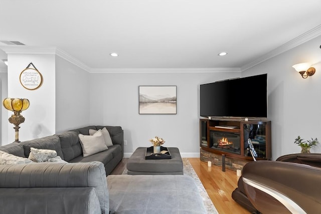21 Starr Dr Unit 207, Narragansett, RI 02882 - living room featuring light wood finished floors, ornamental molding, a glass covered fireplace, and recessed lighting