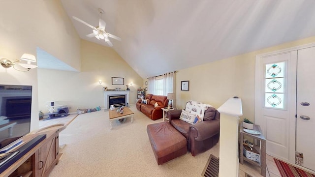 carpeted living room featuring ceiling fan and high vaulted ceiling