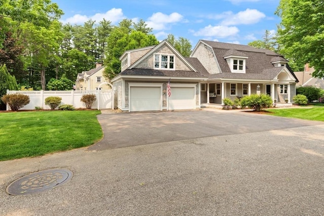 1 Bridge Ln, Newburyport, MA 01950 - view of front facade with covered porch, asphalt driveway, roof with shingles, and a garage