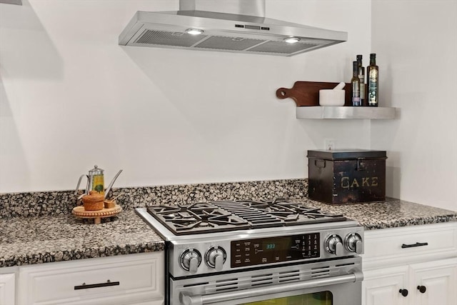 1 Bridge Ln, Newburyport, MA 01950 - kitchen featuring stainless steel gas range, extractor fan, white cabinetry, and dark stone countertops