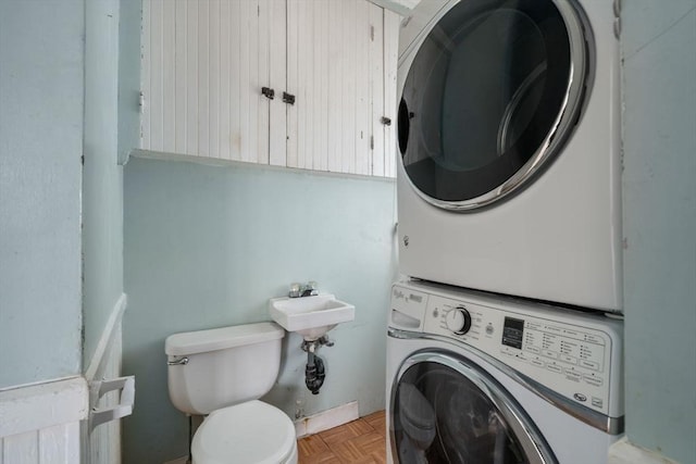 laundry room with laundry area and stacked washer / drying machine