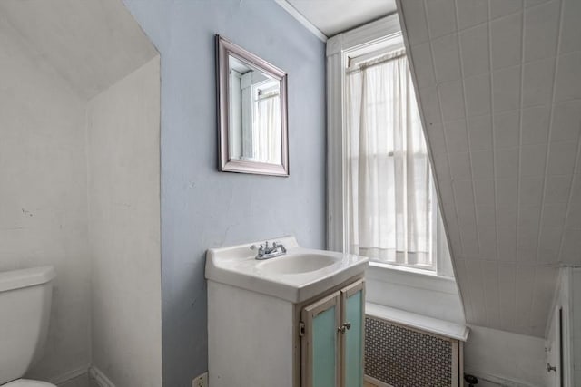 bathroom with toilet, radiator heating unit, and vanity