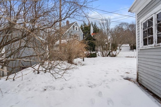 yard covered in snow with fence