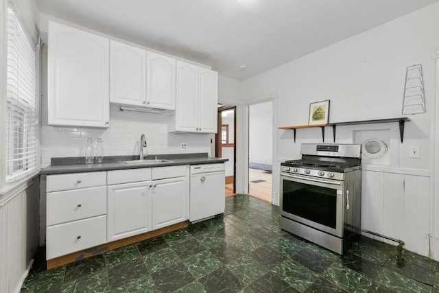 69 Dracut, Boston, MA 02124 - kitchen featuring gas stove, dishwasher, dark countertops, white cabinets, and wainscoting