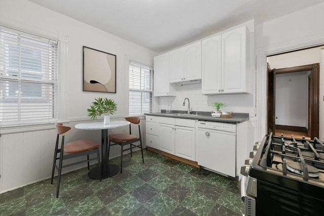 69 Dracut, Boston, MA 02124 - kitchen with white dishwasher, gas range, dark countertops, white cabinets, and dark flooring