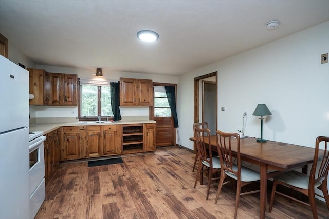 32 Birch Rd, Goshen, MA 01032 - kitchen featuring white appliances, dark wood-style floors, a sink, light countertops, and brown cabinets
