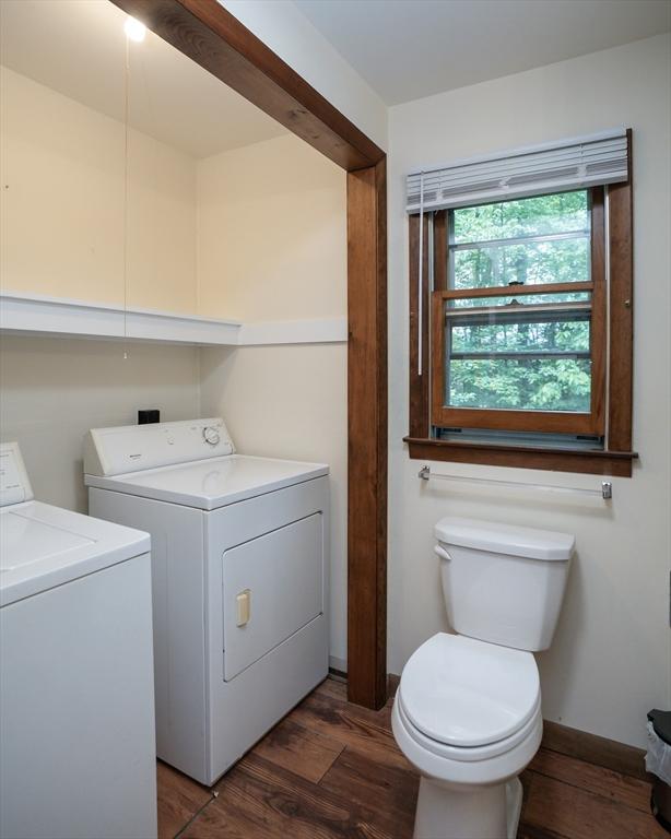 32 Birch Rd, Goshen, MA 01032 - bathroom featuring washing machine and clothes dryer, toilet, wood finished floors, and baseboards