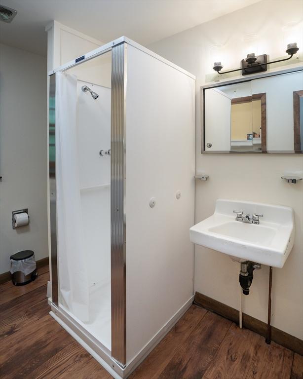 32 Birch Rd, Goshen, MA 01032 - full bath featuring wood finished floors, a shower stall, baseboards, and a sink