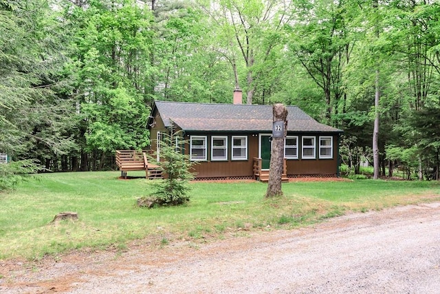 32 Birch Rd, Goshen, MA 01032 - view of front of property featuring a shingled roof, a chimney, a front yard, a deck, and a forest view