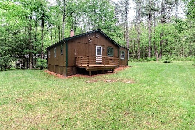 32 Birch Rd, Goshen, MA 01032 - rear view of property with a chimney, a deck, a lawn, and a view of trees