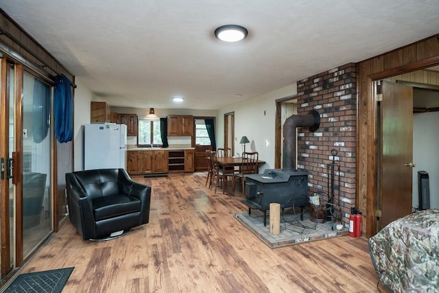 32 Birch Rd, Goshen, MA 01032 - living room with light wood-style flooring, a wood stove, and wine cooler