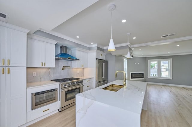 97 Oakton Ave, Boston, MA 02122 - kitchen featuring wall chimney exhaust hood, high quality appliances, a sink, light wood-style flooring, and white cabinets