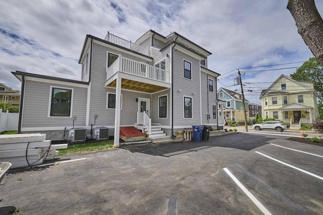 97 Oakton Ave, Boston, MA 02122 - view of property with a balcony, uncovered parking, entry steps, and central air condition unit