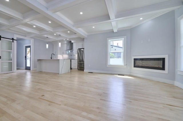 97 Oakton Ave, Boston, MA 02122 - unfurnished living room featuring beam ceiling, a barn door, coffered ceiling, a glass covered fireplace, and baseboards