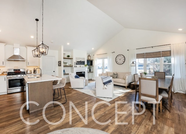 living room featuring an inviting chandelier, high vaulted ceiling, dark wood-type flooring, and sink