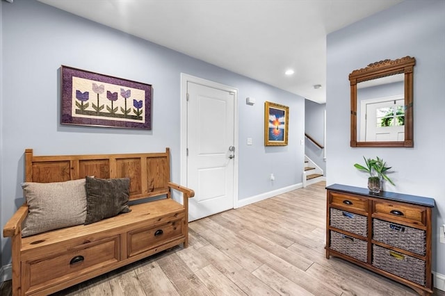 foyer entrance featuring baseboards, stairs, recessed lighting, and light wood-type flooring